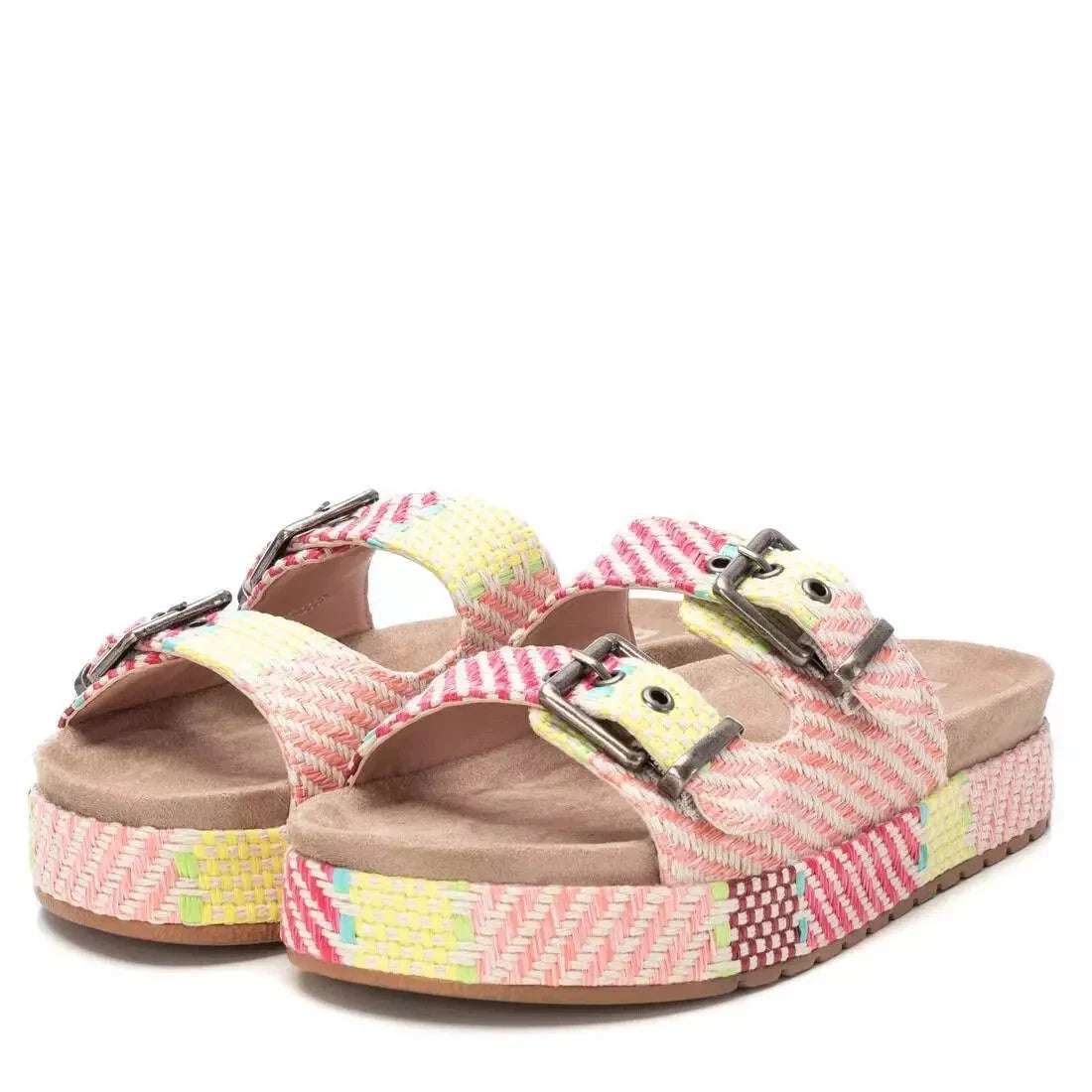 A pair of double buckle sandals with a platform sole, featuring woven pink, yellow and cream straps, adjustable metal buckles, and tan footbeds.