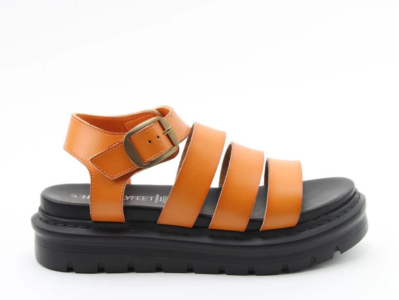 A single orange strappy vegan sandal with a thick black sole and a gold buckle, displayed against a plain white background—perfect for lightweight summer style.