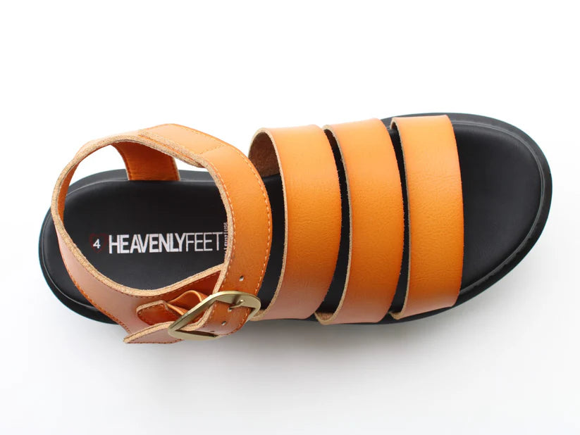A tan strappy summer sandal with a gold buckle and black sole, labelled Heavenly Feet on the insole, shown from a top-down view.