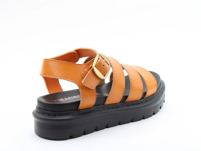 Orange leather summer sandal with a thick black sole, gold buckle, and three straps across the front, photographed against a white background—perfect lightweight sandals for sunny days.