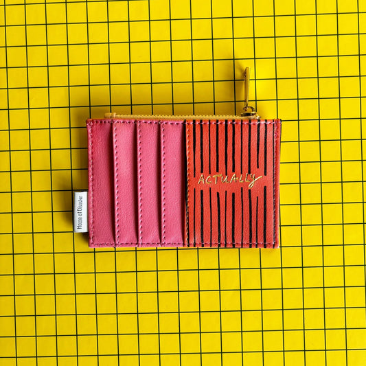 A pink and black striped cheeky zip purse labelled ACTUALLY sits on a yellow grid-patterned background, making an amusing gift for anyone who loves quirky style.
