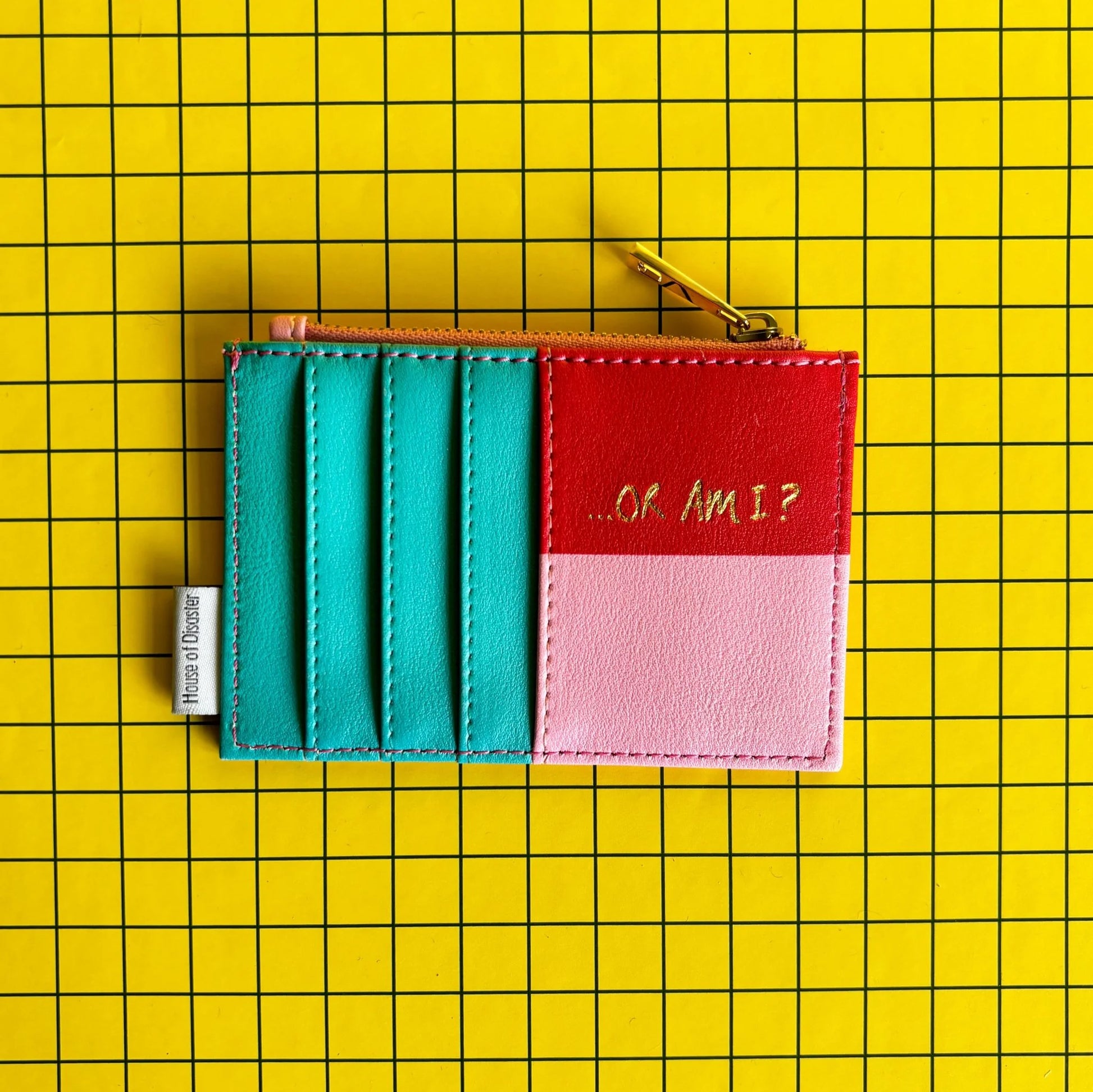 A compact purse with card slots and a zip, this clever gift displays “…OR AM I?” on a yellow, grid-patterned background—ideal for anyone prone to overthinking.
