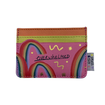 A pocket-sized card holder with rainbow designs, gold stars, and OVERWHELMED across the centre—ideal as a cheerful gift for friends. A small tag on the side reads SMALL TALK.