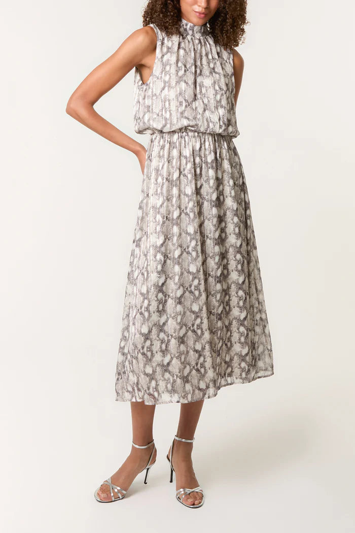 A person dressed in a sleeveless, ankle-length snake print dress with a gathered neckline, teamed with strappy high-heeled sandals.