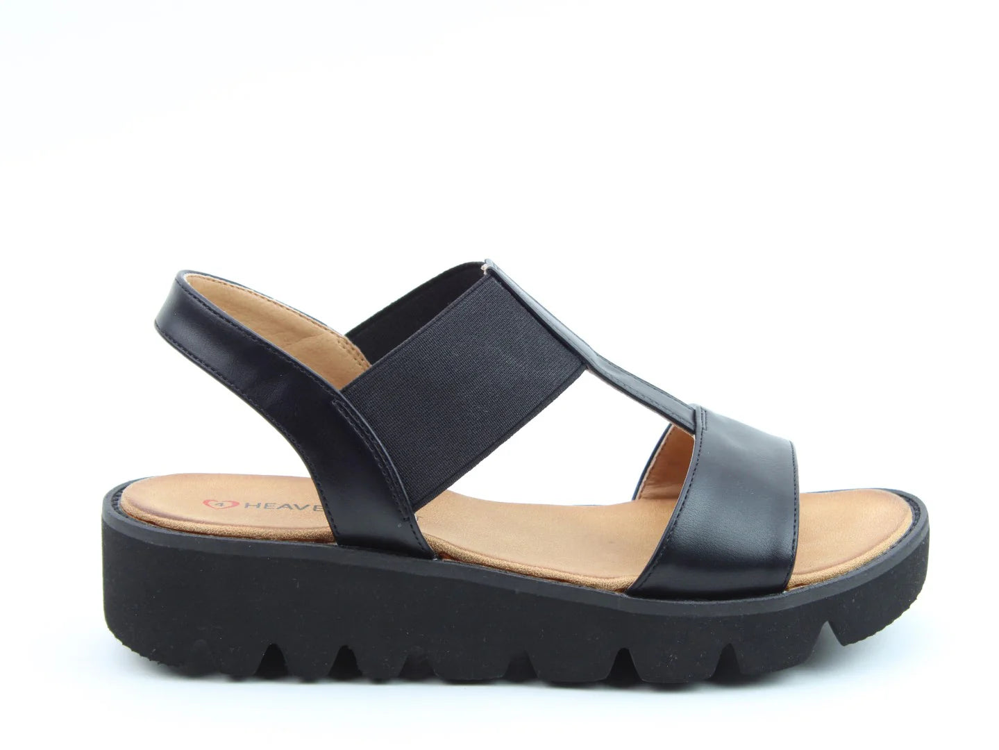 The Ritz Casual Sandals are black open-toe wedges featuring a wide elastic strap, leather upper, thick rubber sole, and a cushioned footbed for all-day comfort.