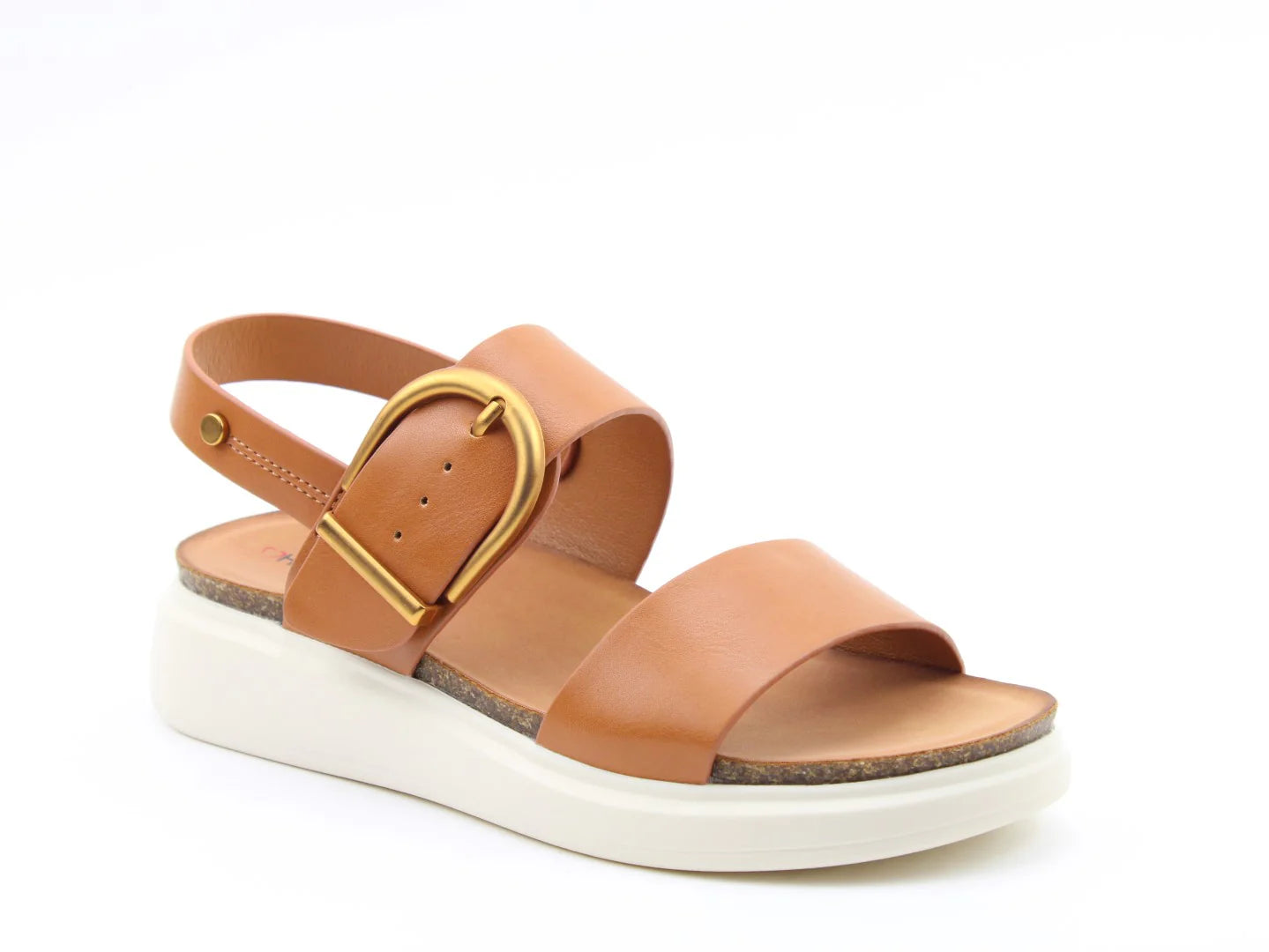 The BERNIE TAN Sandals boast a brown design with a large gold buckle and two straps, ideal for the summer look. These vegan-friendly sandals also feature a white wedge sole and an adjustable back strap.