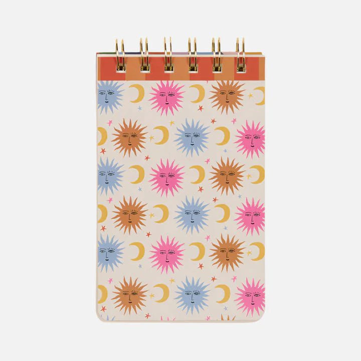 Spiral Sun Flip Notebook with a cover showcasing a repeating pattern of colourful suns, crescent moons, and stars on a light background—cheerful stationery inspired by Mediterranean notebook designs.