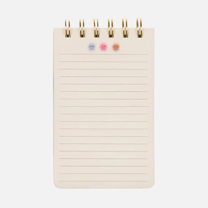 A small spiral-bound Sun Flip Notebook with lined pages and three starburst designs in blue, pink, and orange at the top—ideal for bringing a splash of cheerful stationery to your day.