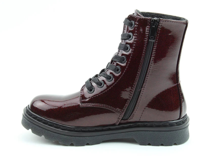 A glossy burgundy combat boot with black laces, a side zip, and thick black sole boasts memory foam insoles for comfort, displayed in side profile against a white background.