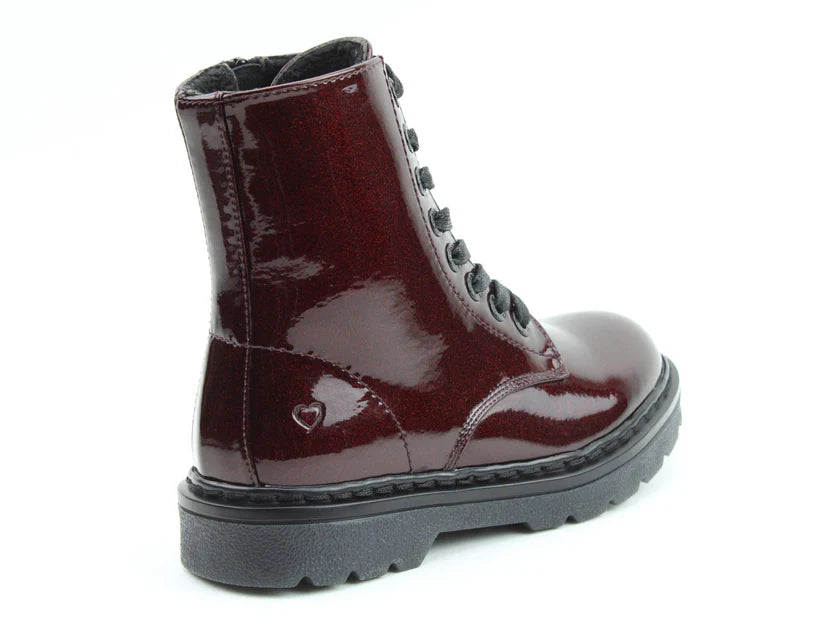 A glossy, dark red lace-up vegan-friendly boot with a chunky black sole and memory foam insoles, featuring a small heart detail on the side near the heel.