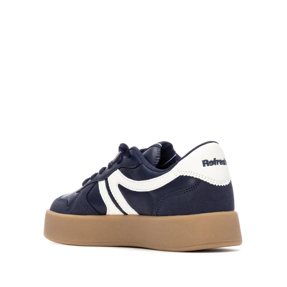 A navy blue and white vegan trainer with a gum sole, viewed from the back side angle, displaying Refresh branding on the heel. This PETA-certified design provides both style and comfort.