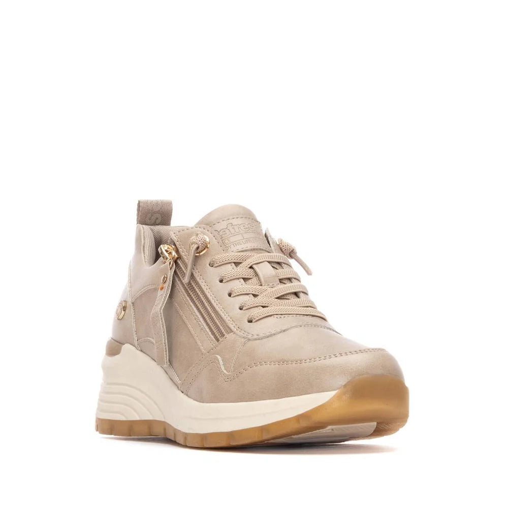 Beige and gold vegan trainers with a chunky white and tan sole, front laces, side zip, leather accents, and removable insoles. PETA-certified vegan, shown against a plain white background.