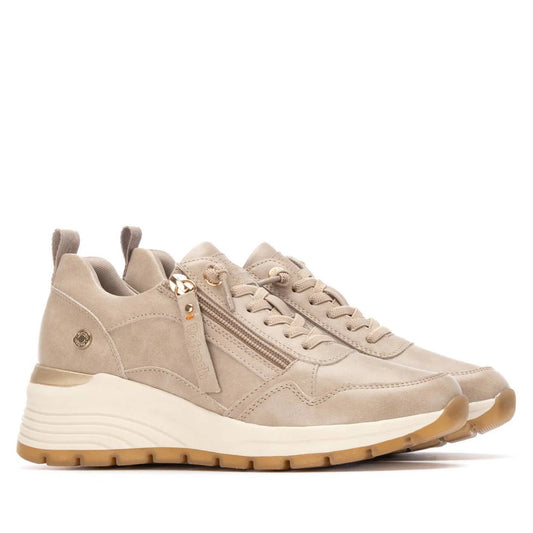 A pair of beige and gold vegan trainers featuring side zips, lace-up fronts, removable insoles, and white rubber soles, displayed against a white background.