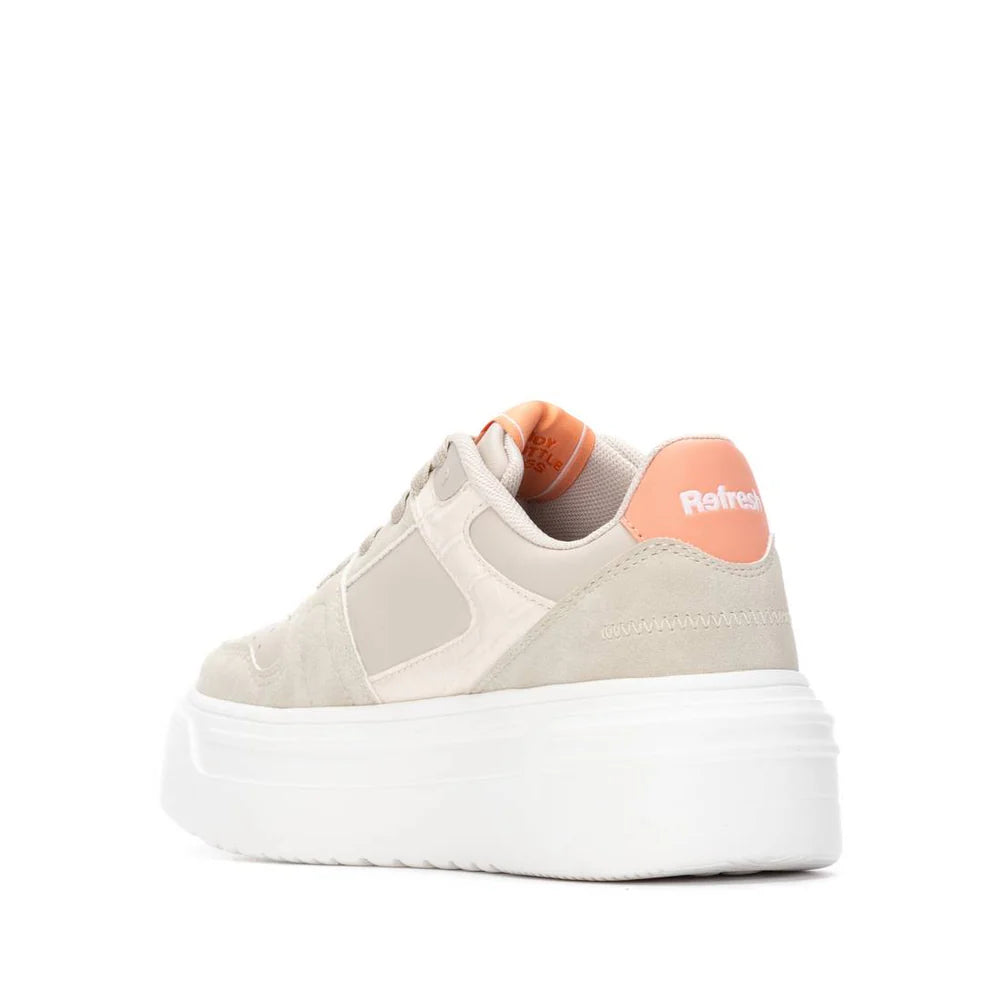 A beige and white platform vegan trainer with an orange heel accent, removable insole, and the brand name Refresh on the back.